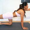 Woman in tabletop pose on a Charcoal Grey waterproof vegan leather yoga mat