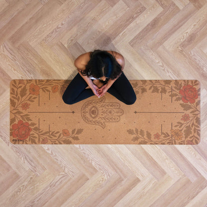 Person meditating on a Zenvibes Hamsa Harmony extra wide cork yoga mat with floral designs.