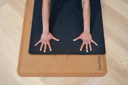 Hands of a person on a Zenvibes Hamsa Harmony extra wide cork yoga mat.